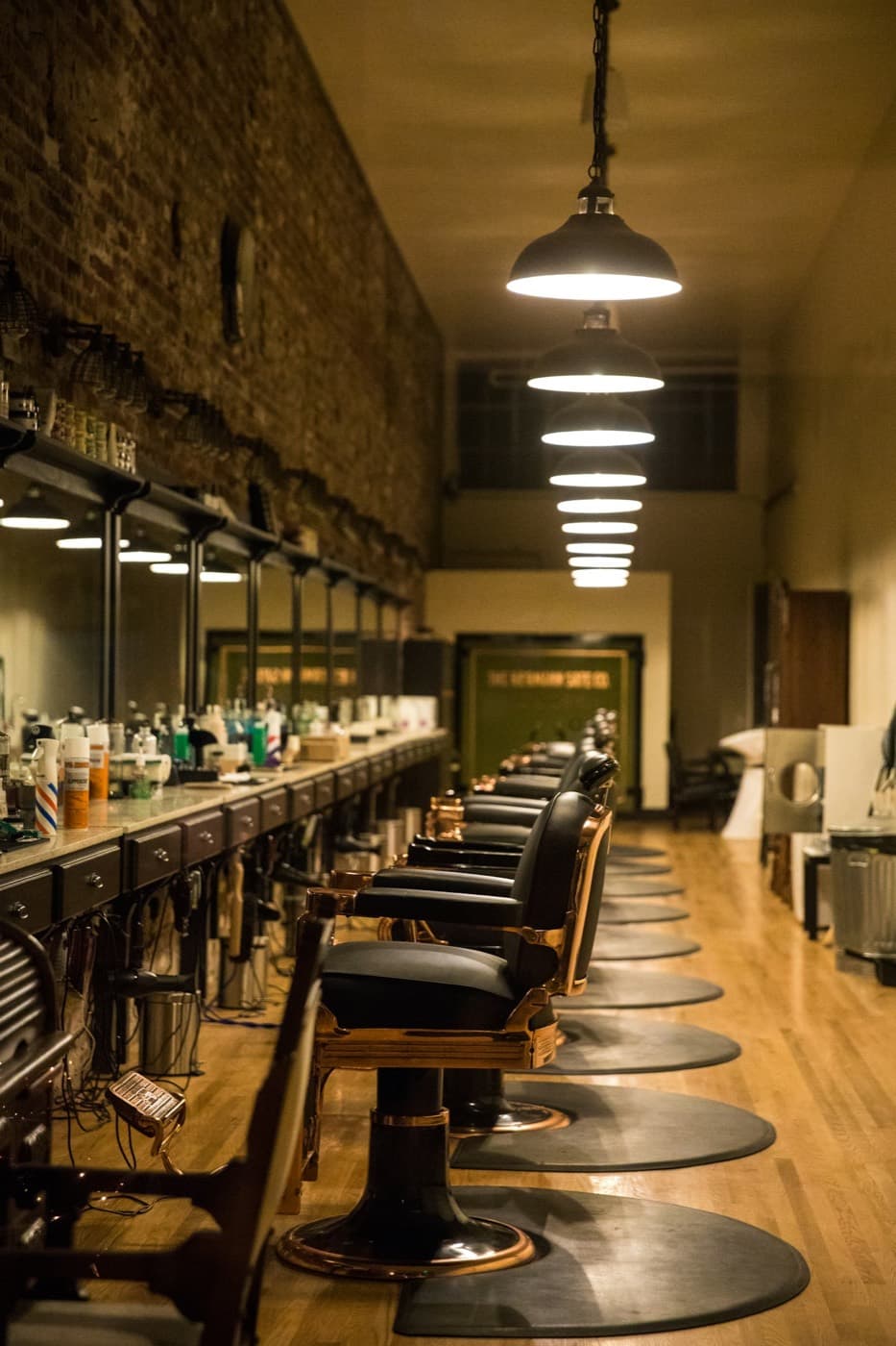 A row of barber chairs down the length of a traditional shop