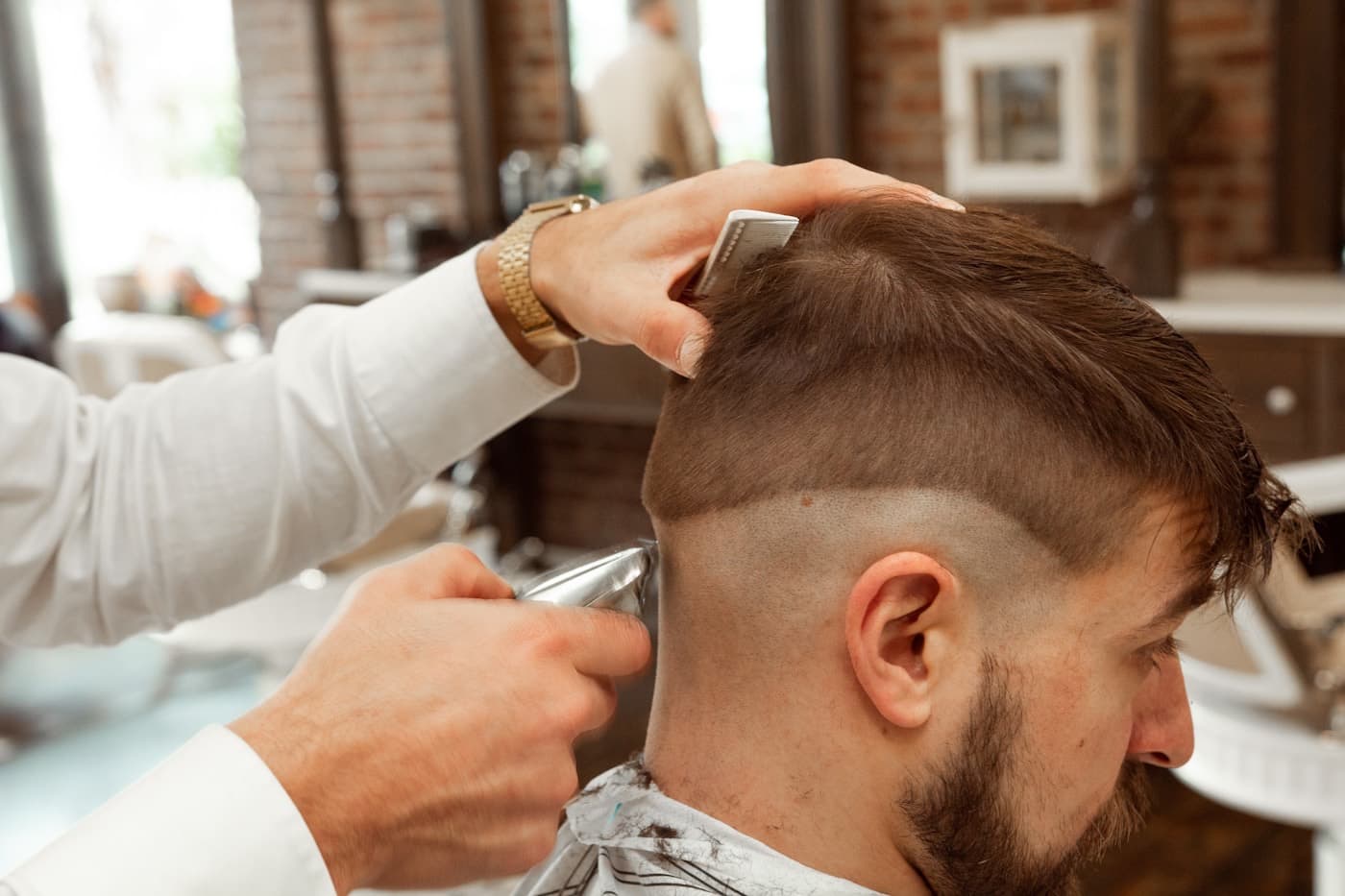 Close-up of a fresh skin fade being cut